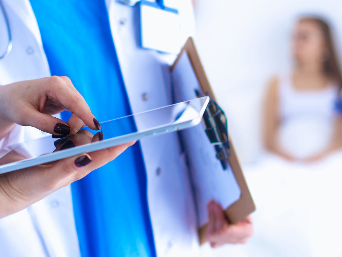 Young woman doctor holding a tablet pc