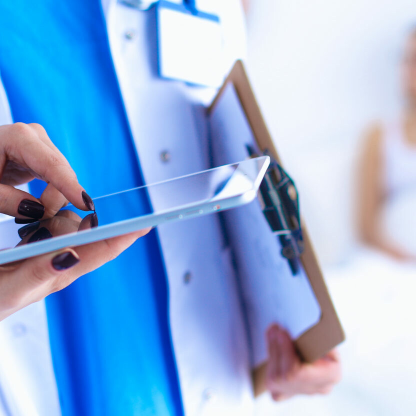 Young woman doctor holding a tablet pc