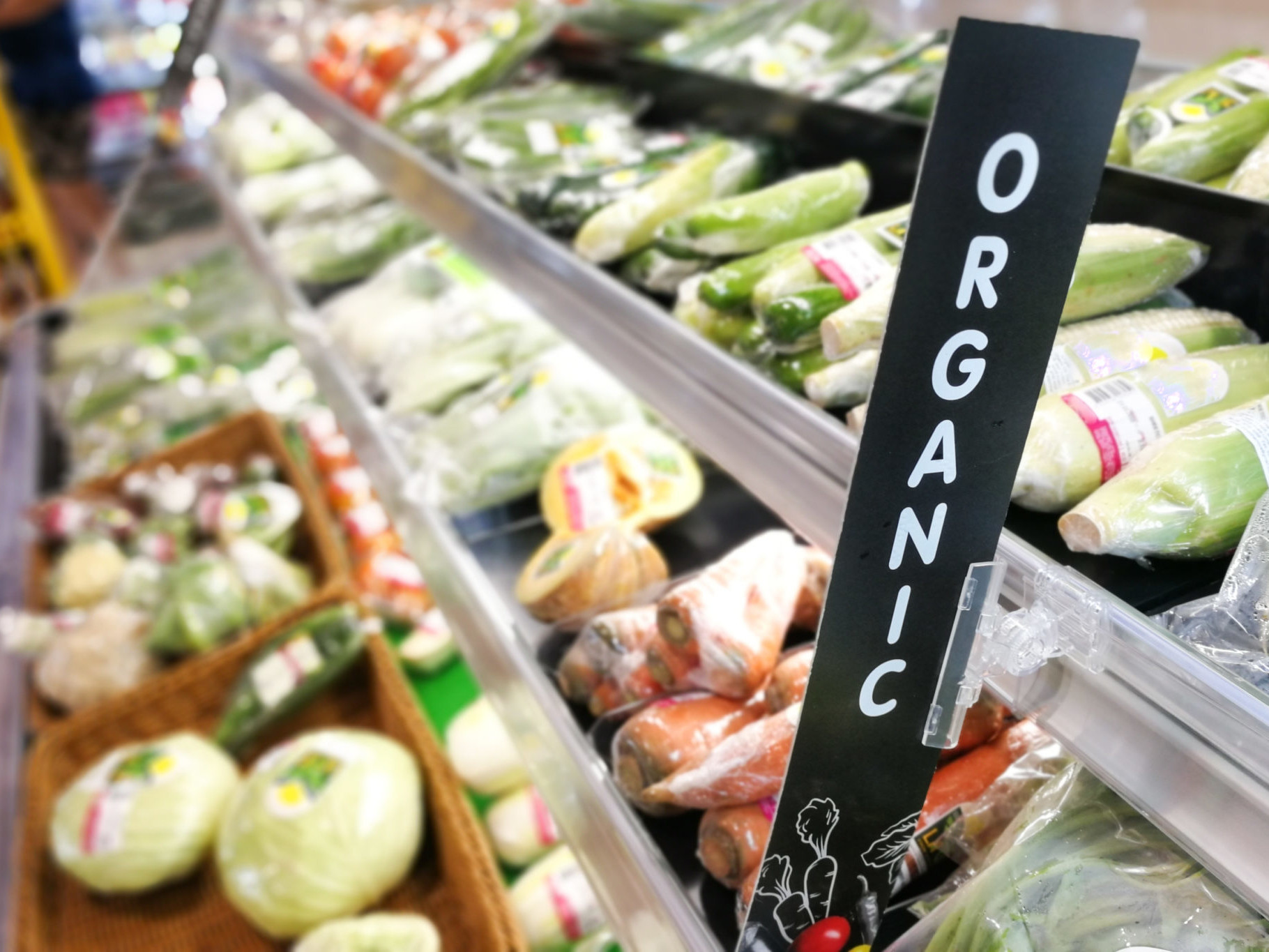 Organic signage at vegetable and fruits produce section of supermarket