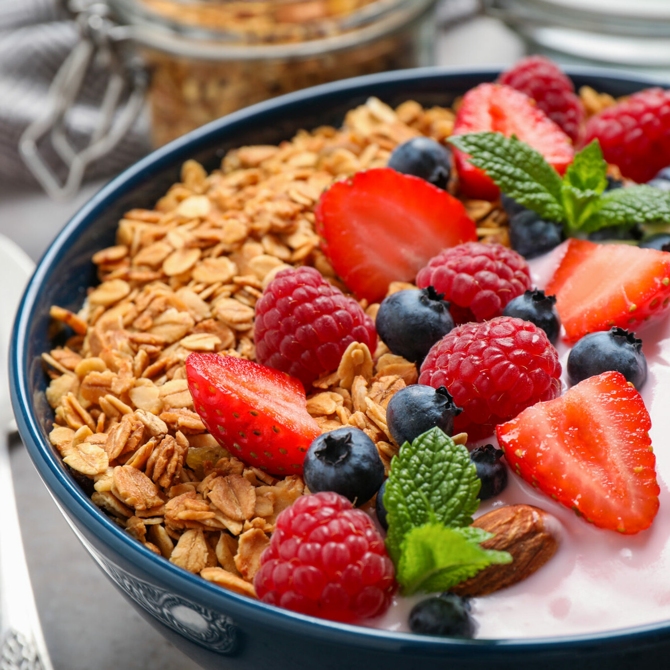 Tasty homemade granola with yogurt on grey table, closeup. Healthy breakfast