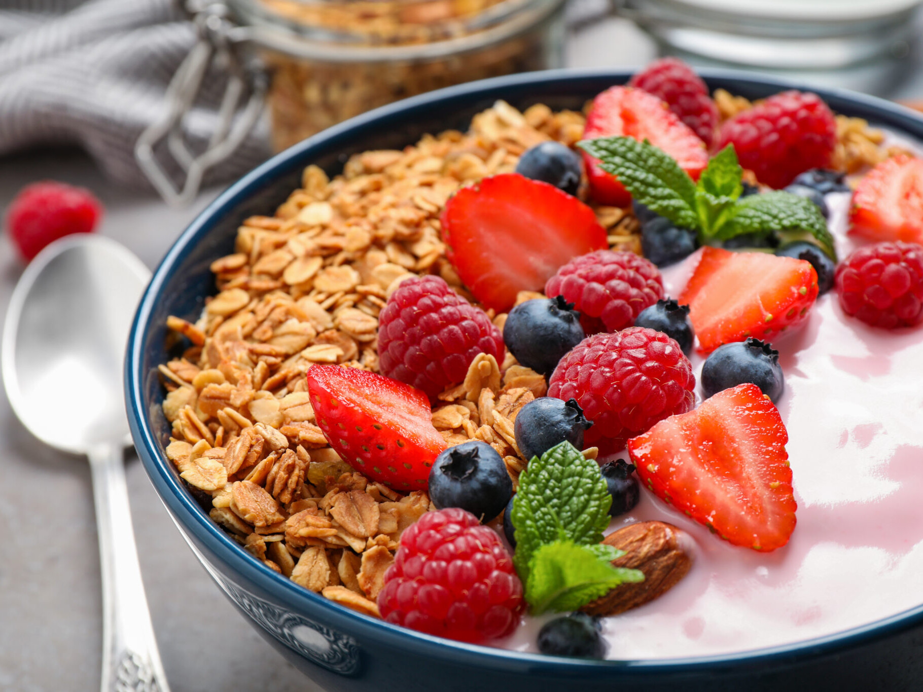 Tasty homemade granola with yogurt on grey table, closeup. Healthy breakfast