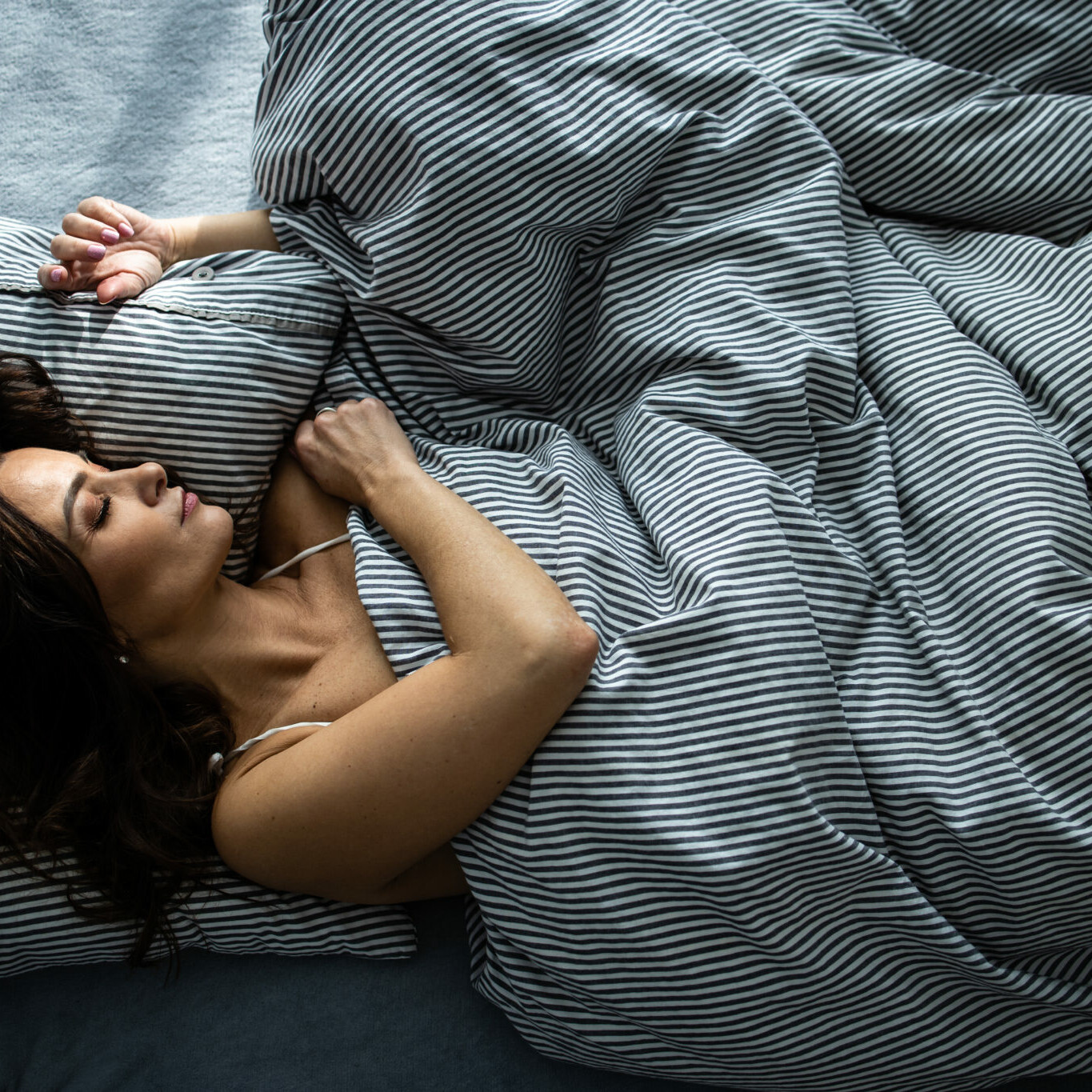 Pretty young woman sleeping in her bed