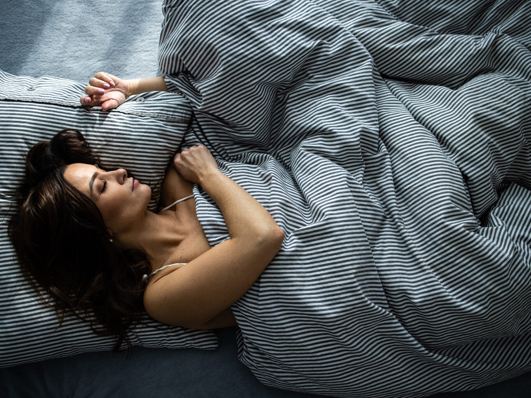 Pretty young woman sleeping in her bed