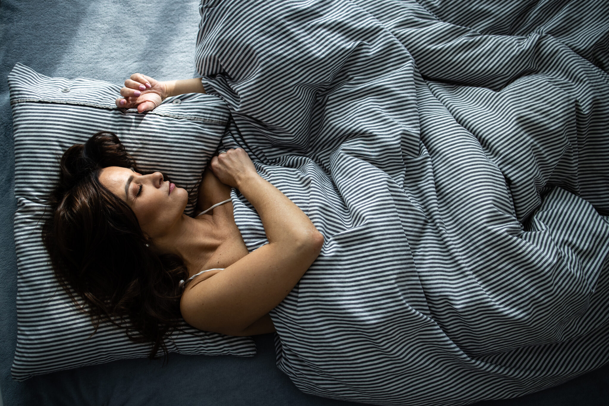 Pretty young woman sleeping in her bed